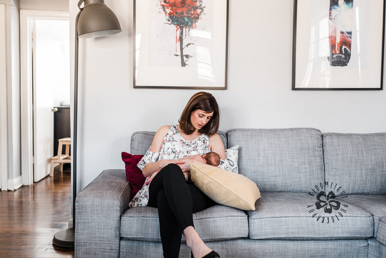 image of mom with her newborn in a modern family living room