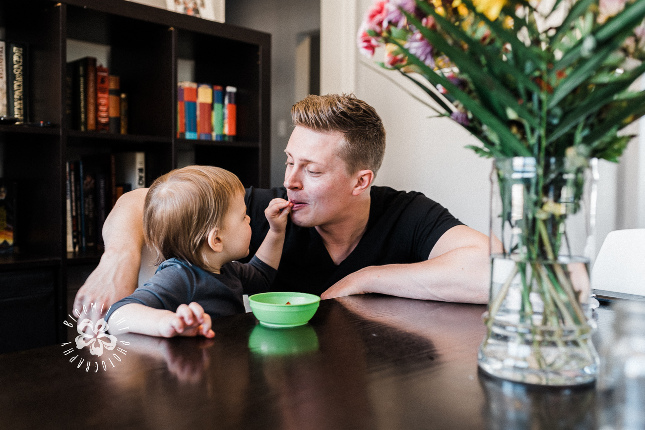 Documentary family photo of a father and his toddler in living room