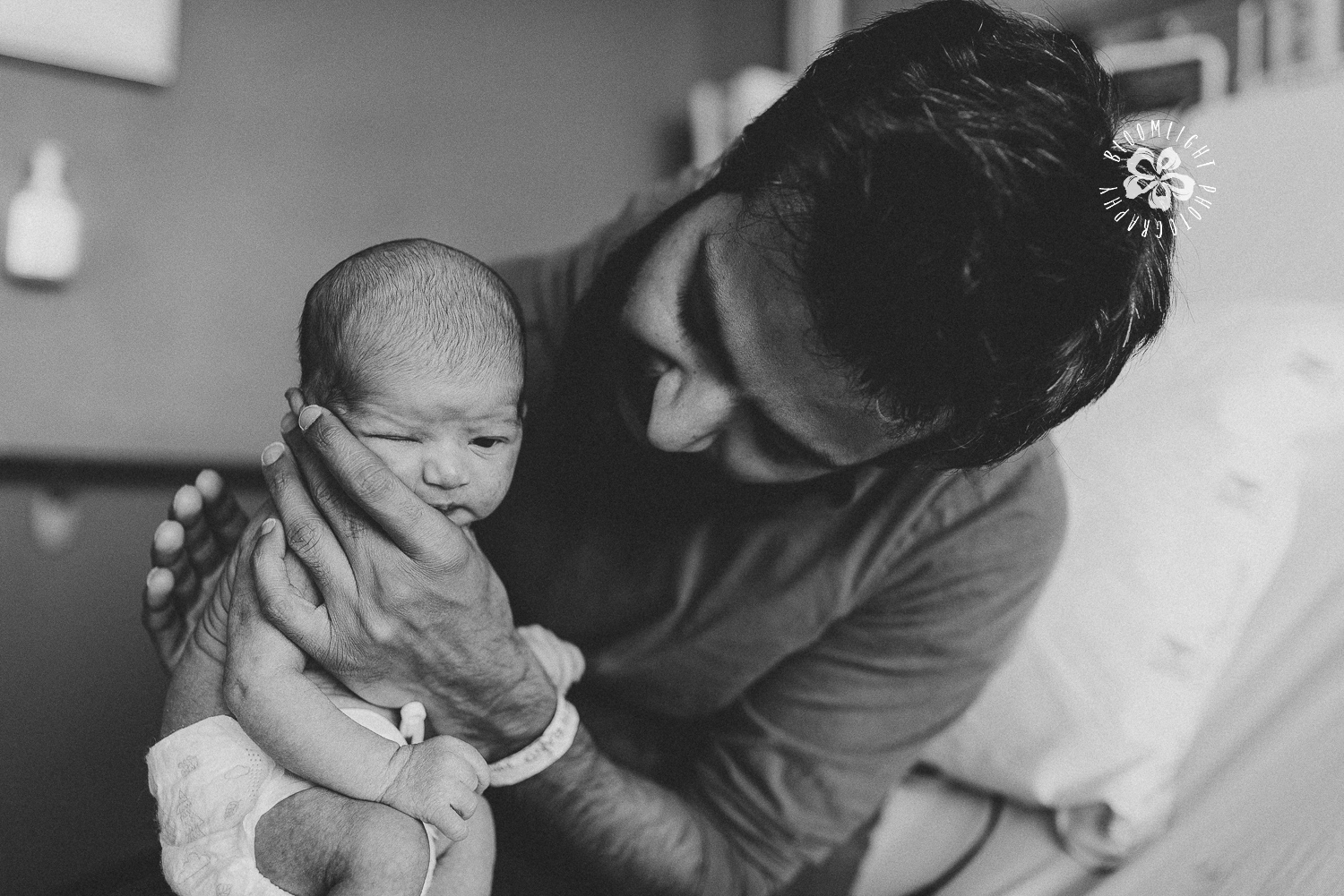 new dad holding his newborn in a hospital in Toronto, photo in black and white