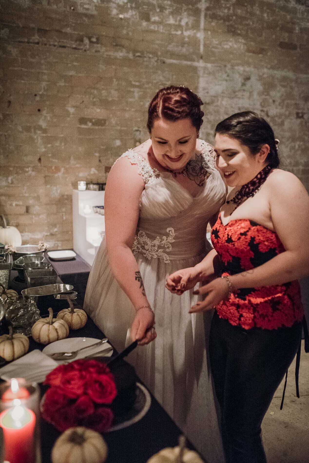 Lesbian brides cutting their wedding cake