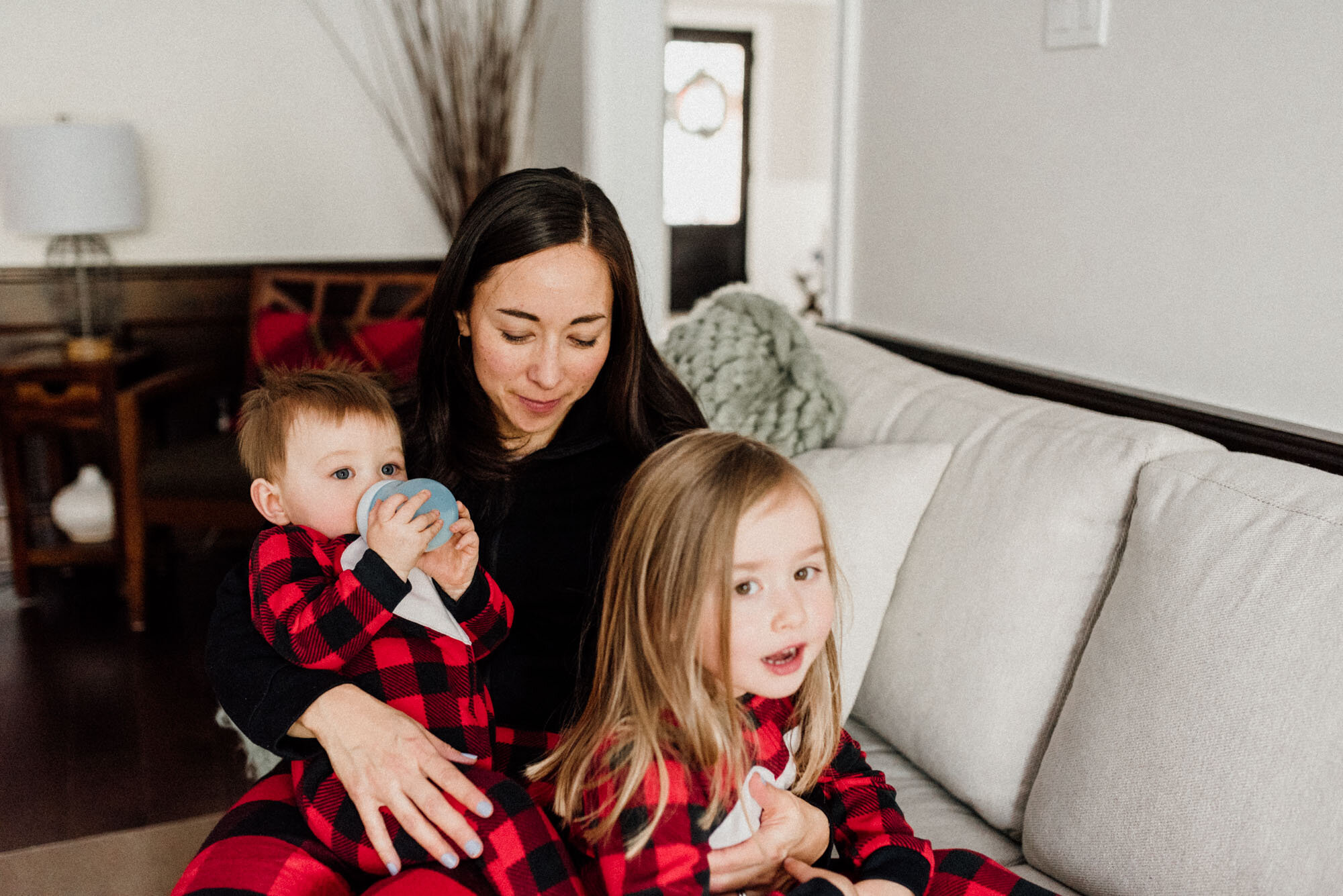 Cuddle time with mommy in Christmas time at home