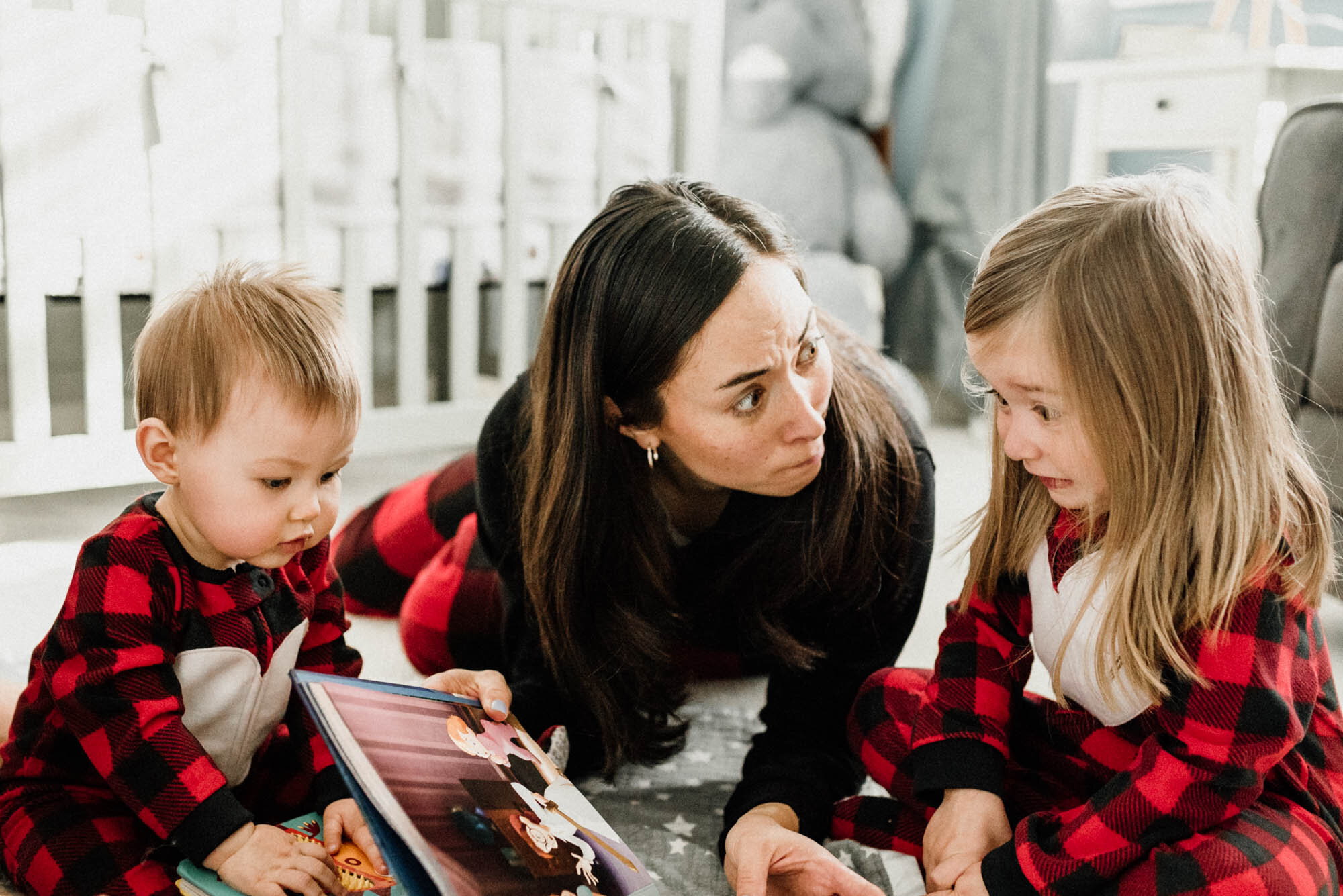 Mom reading book for her babies at Christmas time