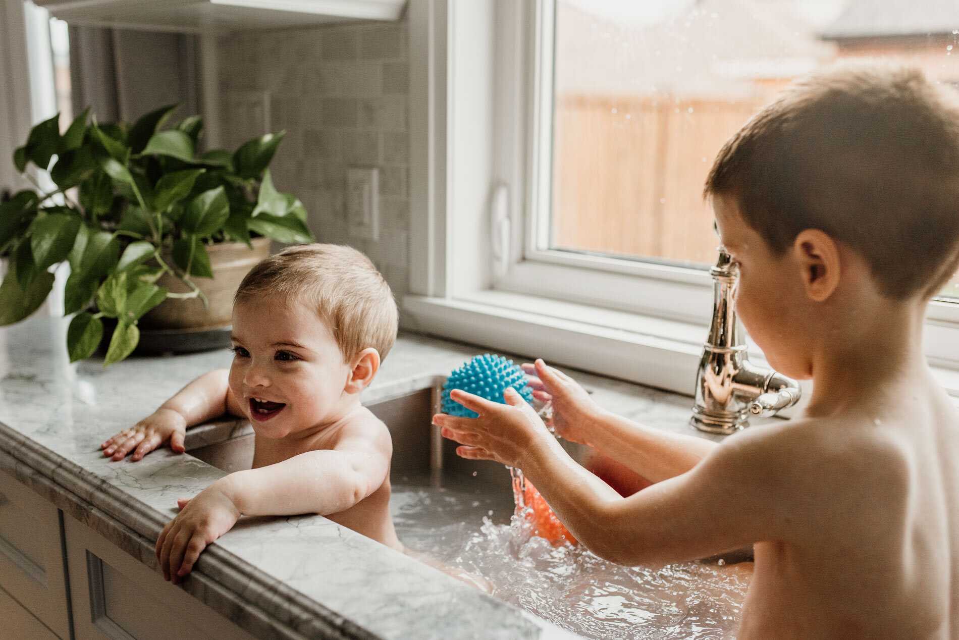 Whitby-photographer-baby-documentary-bath-in-kitchen-sink-fun-picture.JPG