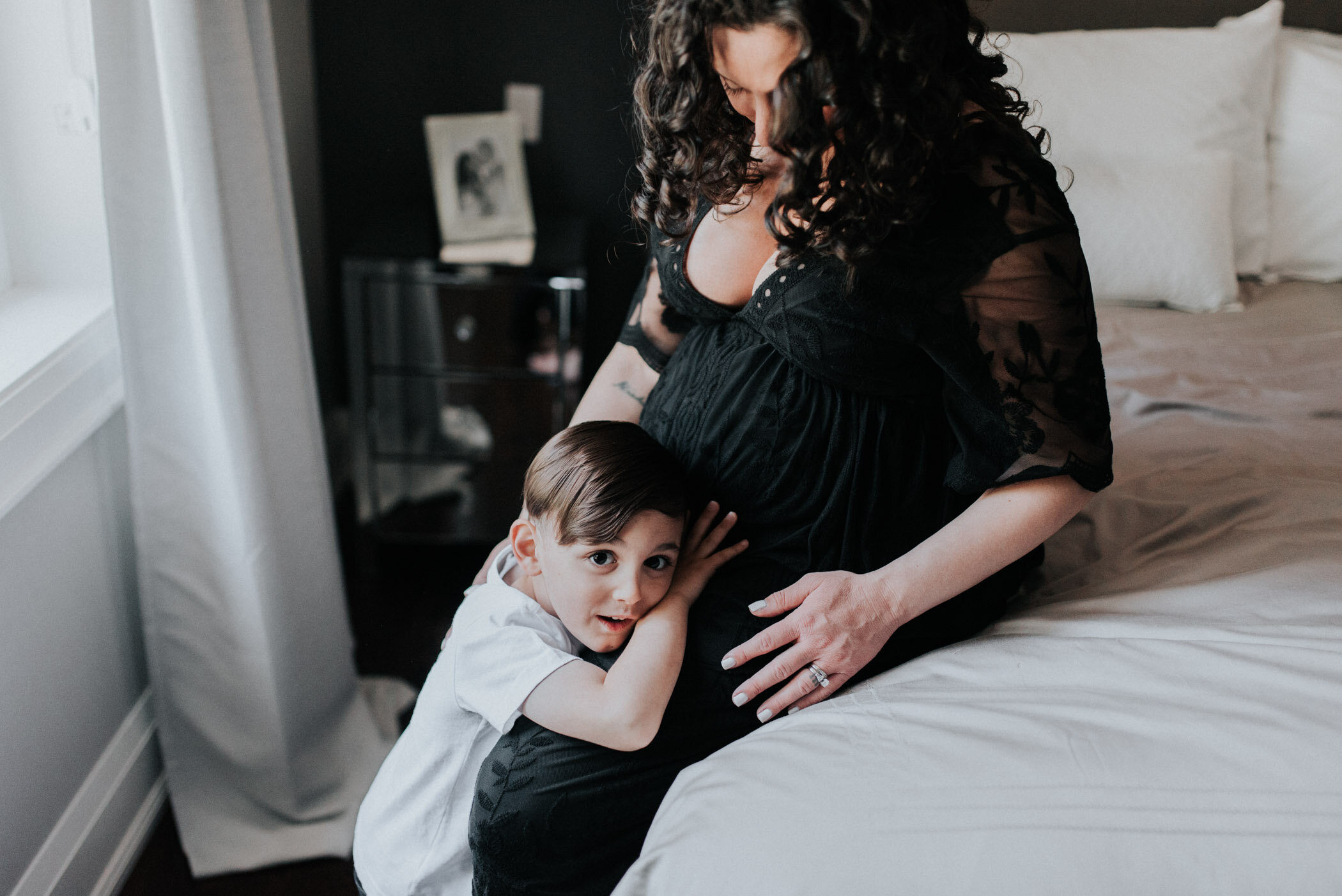 picture of pregnant mom with her toddler son in the bedroom at home in Toronto