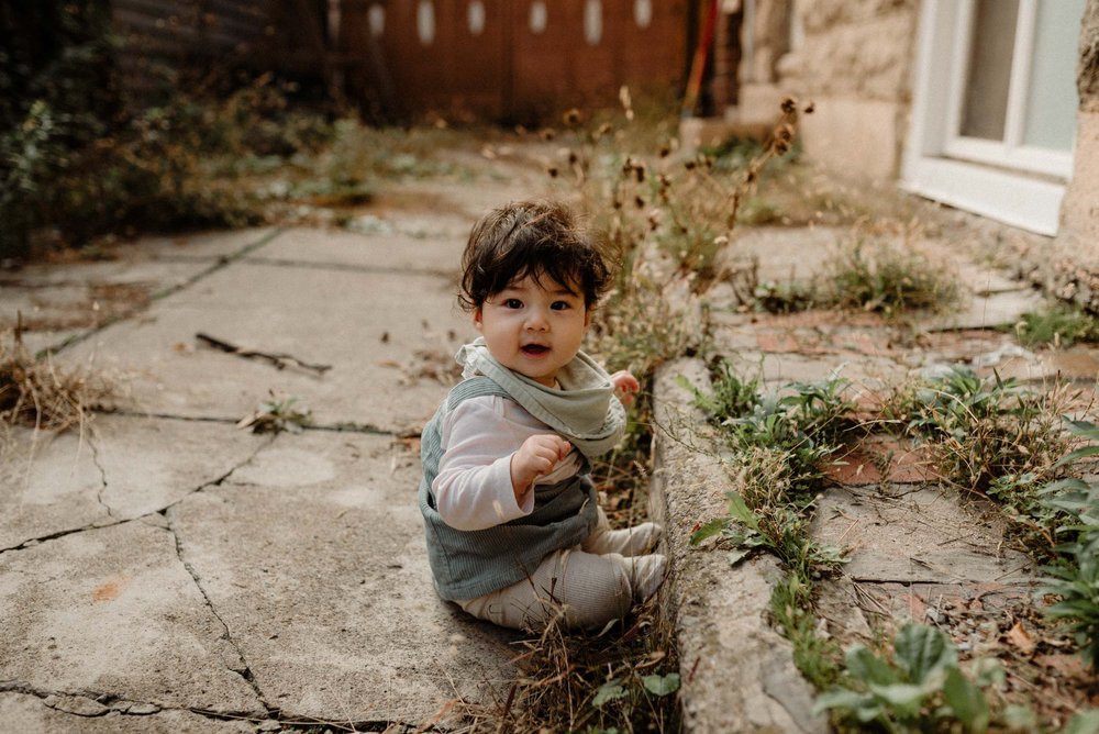 photo of a 7 months baby sitting in a Toronto neighborhood 