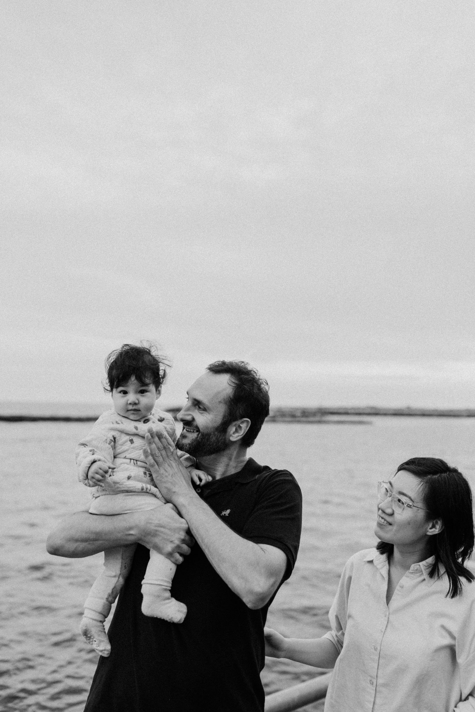 Black and white picture of a family with a baby at Toronto waterfront
