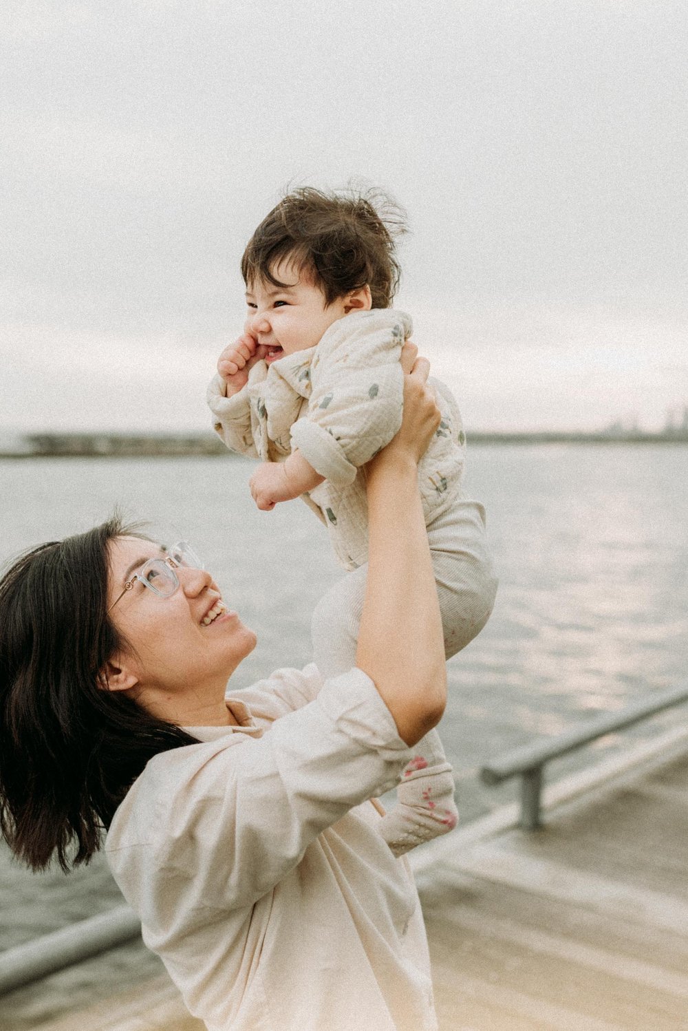 Joyful moment of mommy and baby at sunset close to Toronto waterfront