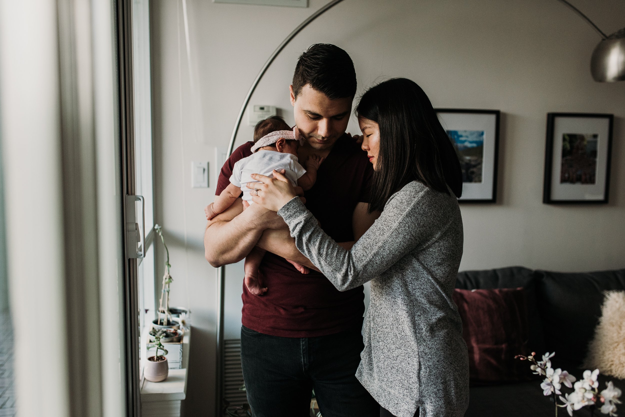 dramatic family photo with newborn at their condo in North York, Toronto 