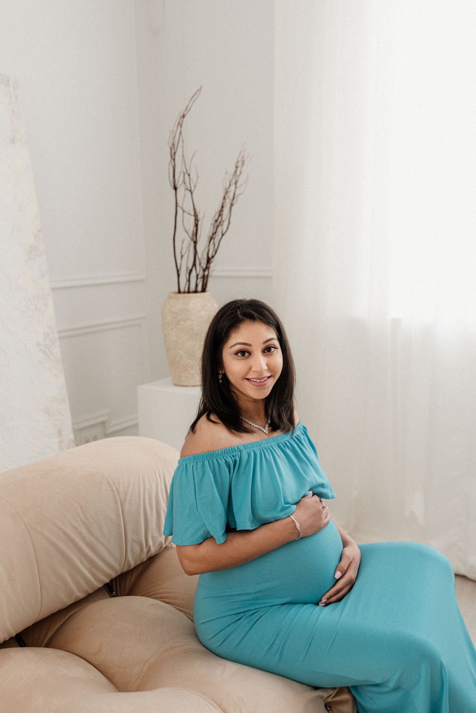 happy pregnant mama in a modern look setting in a Toronto studio