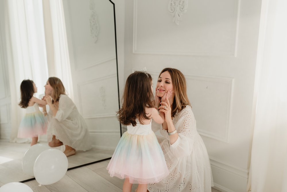 Mommy and girl photo kissing each other in a Toronto studio