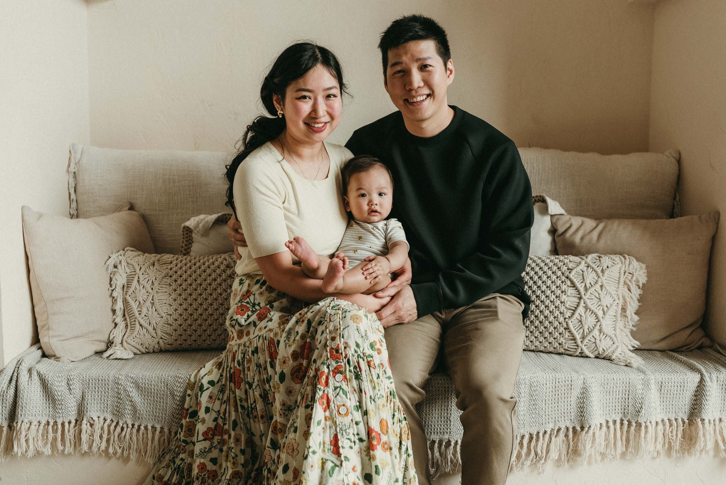 Family portrait of parents with their 6 months old baby in a Toronto studio