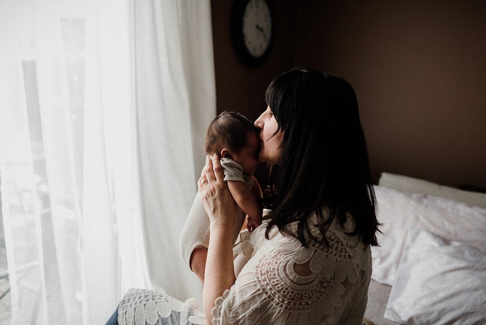 Mom and baby cuddle at home in Whitby