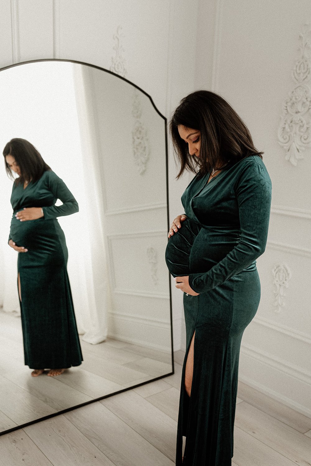 pregnant mommy in velvet green dress in studio