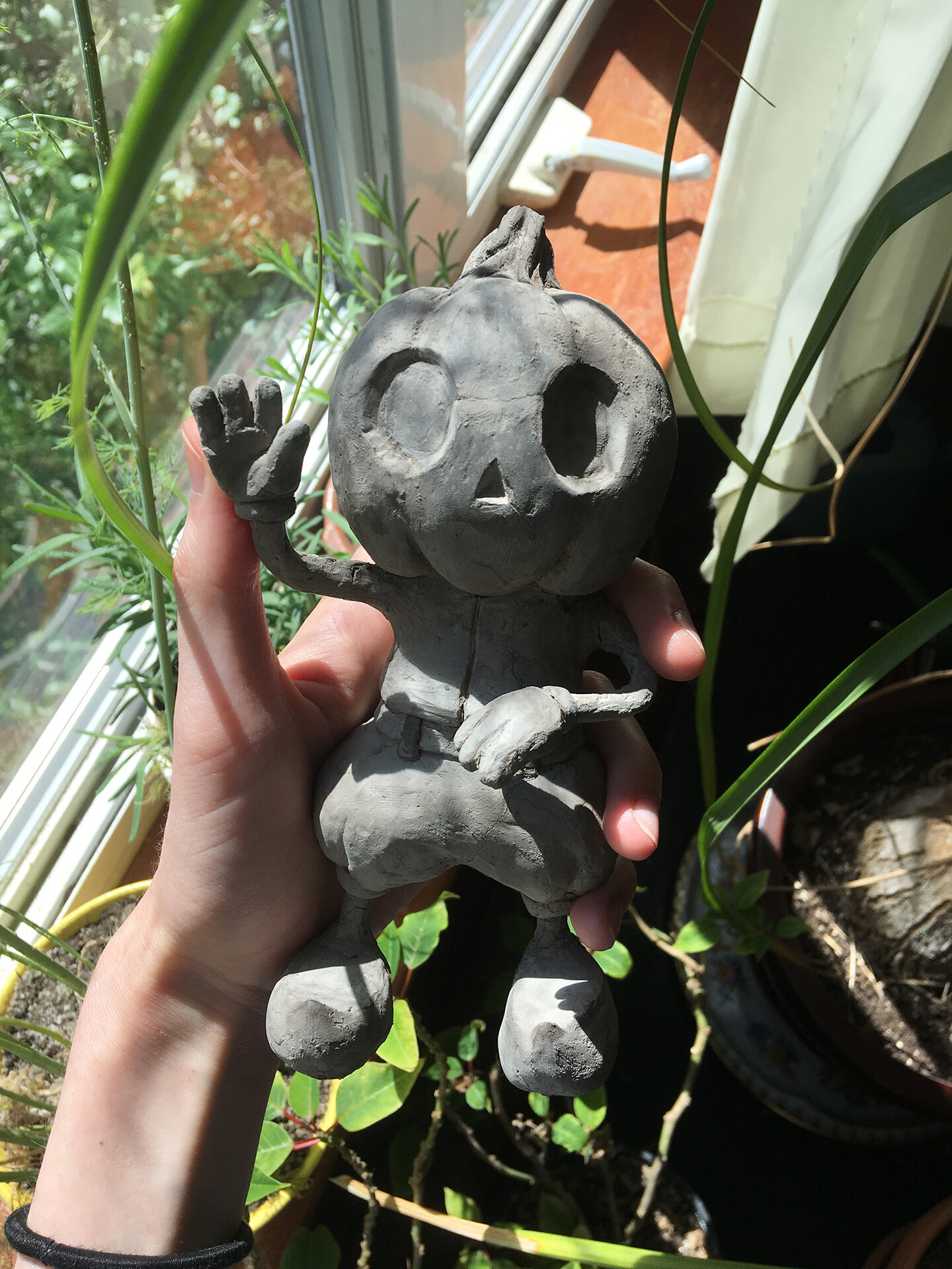 15. Clyde in My Hand with Some Plants.jpg