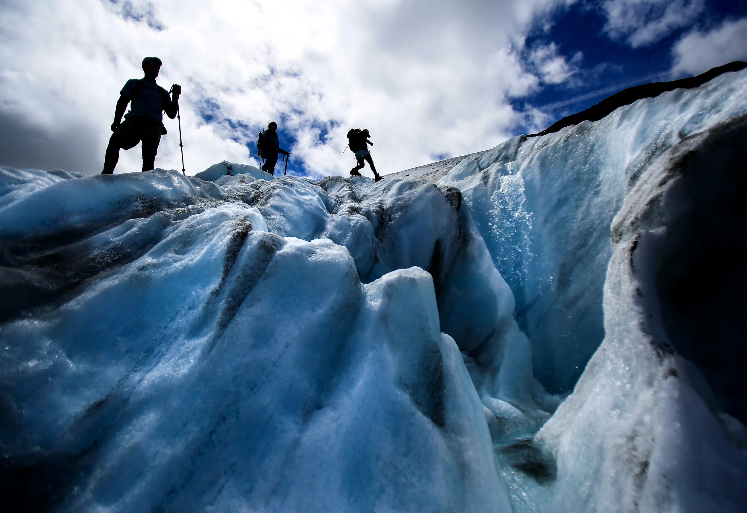 Research assistants navigate around a supraglacial stream on Mt. Baker's Sholes Glacier as they make measurements to assess the volume lost that will be added to the 32 years of data recorded by Glaciologist Mauri Pelto, Friday, Aug. 7, 2015. The glacier has receded over 90 meters, said Pelto. (Sy Bean / The Seattle Times)
