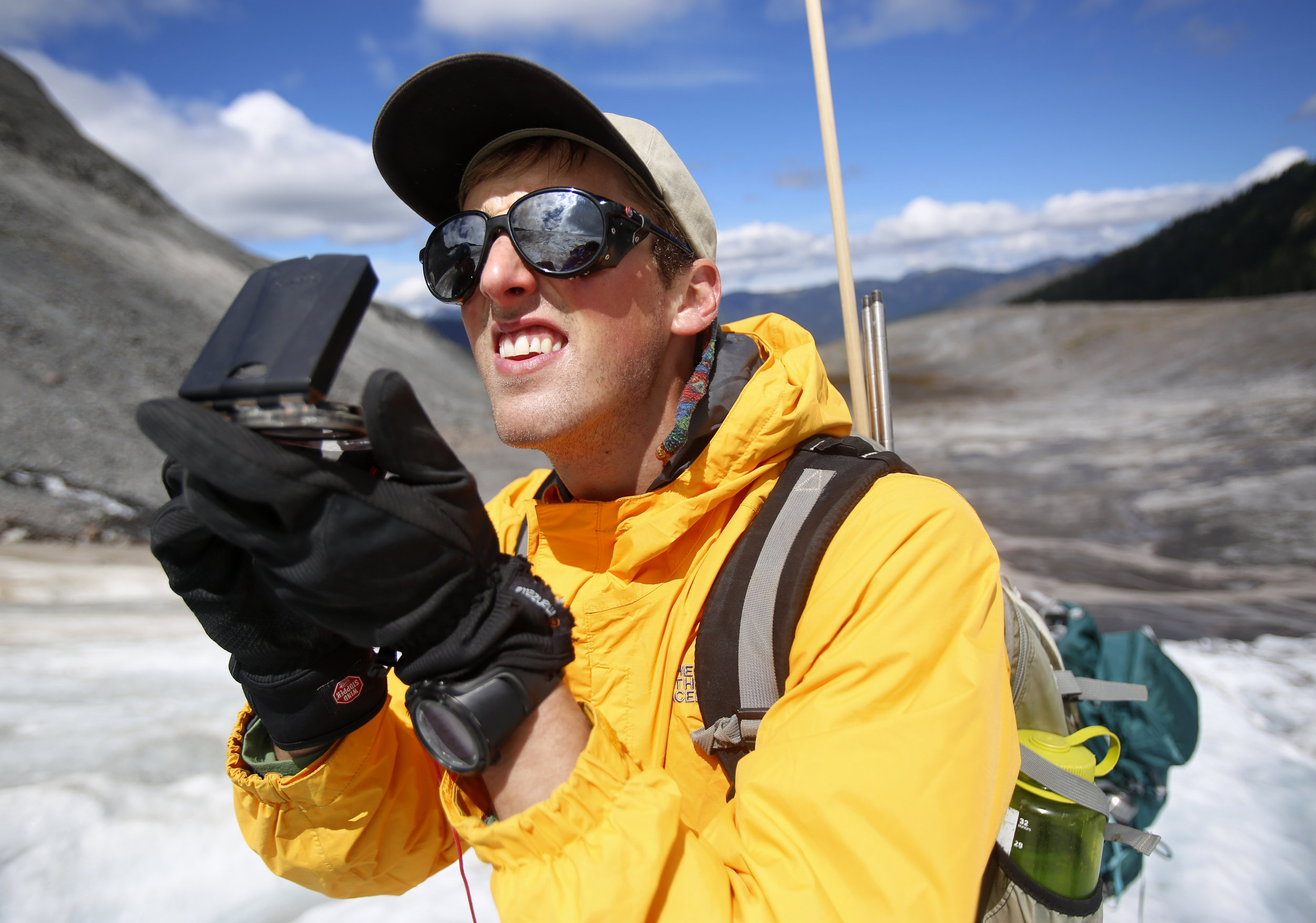  Ben Pelto, son of Mauri Pelto, uses a compass to map the size of Sholes Glacier. 