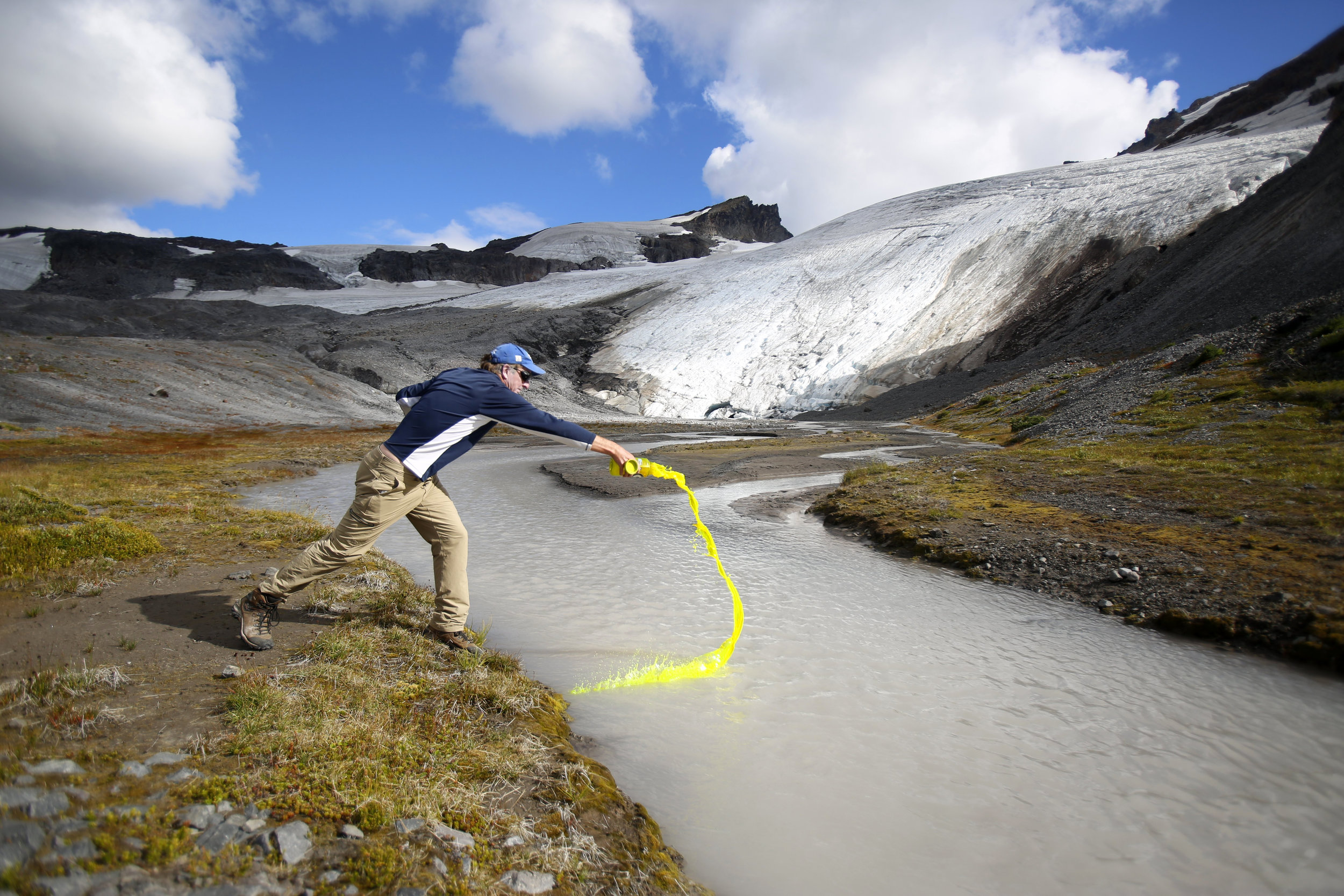  Glaciologist Mauri Pelto pours biodegradable dye into a runoff stream Friday, Aug. 7, 2015, in order to measure the volume of runoff on Sholes Glacier, on the northeast slope of Mount Baker. The glacier has receded more than 90 meters, or nearly 300