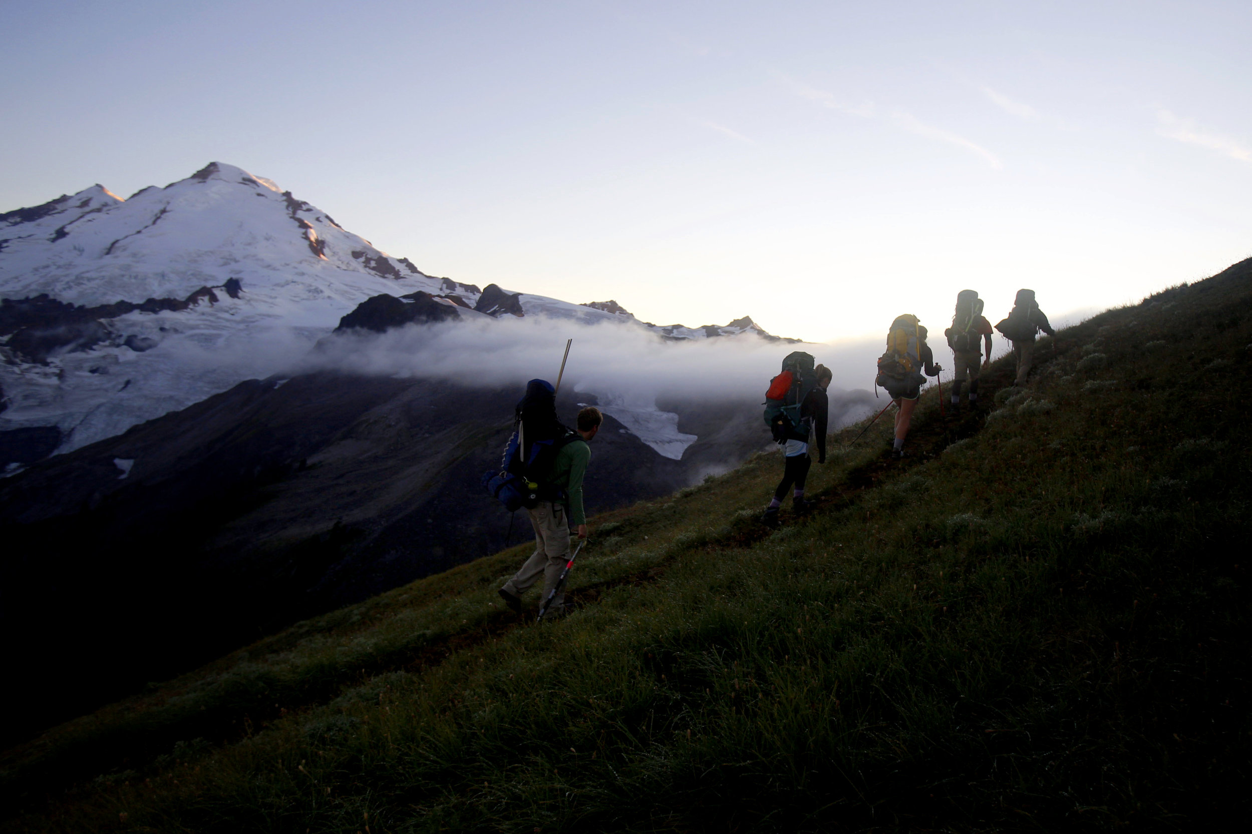  The research team heads toward a campsite as Mount Baker catches the last of the day’s light on Thursday, Aug. 6, 2015. This is Pelto’s 32nd year collecting data on Sholes Glacier.     