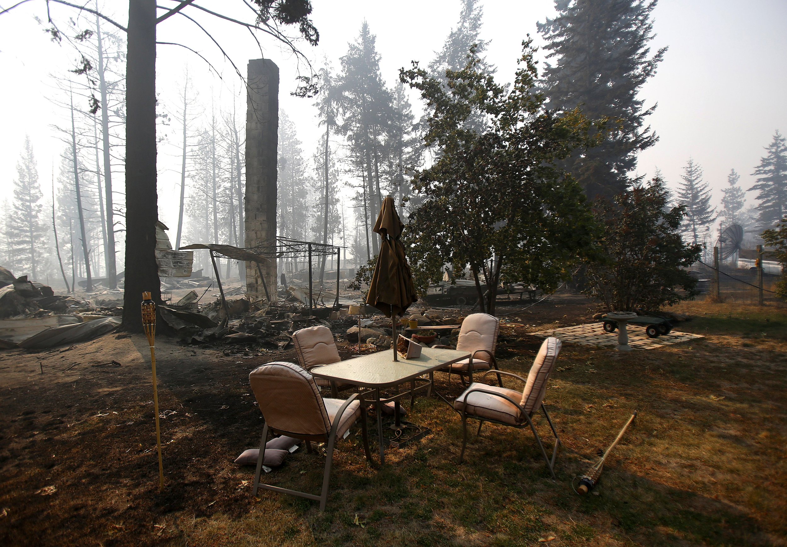  Patio furniture remains relatively untouched after a wildfire swept through the community on White Rock Road, destroying several houses, in Okanogan, Wash., Sunday, Aug. 23, 2015. 
