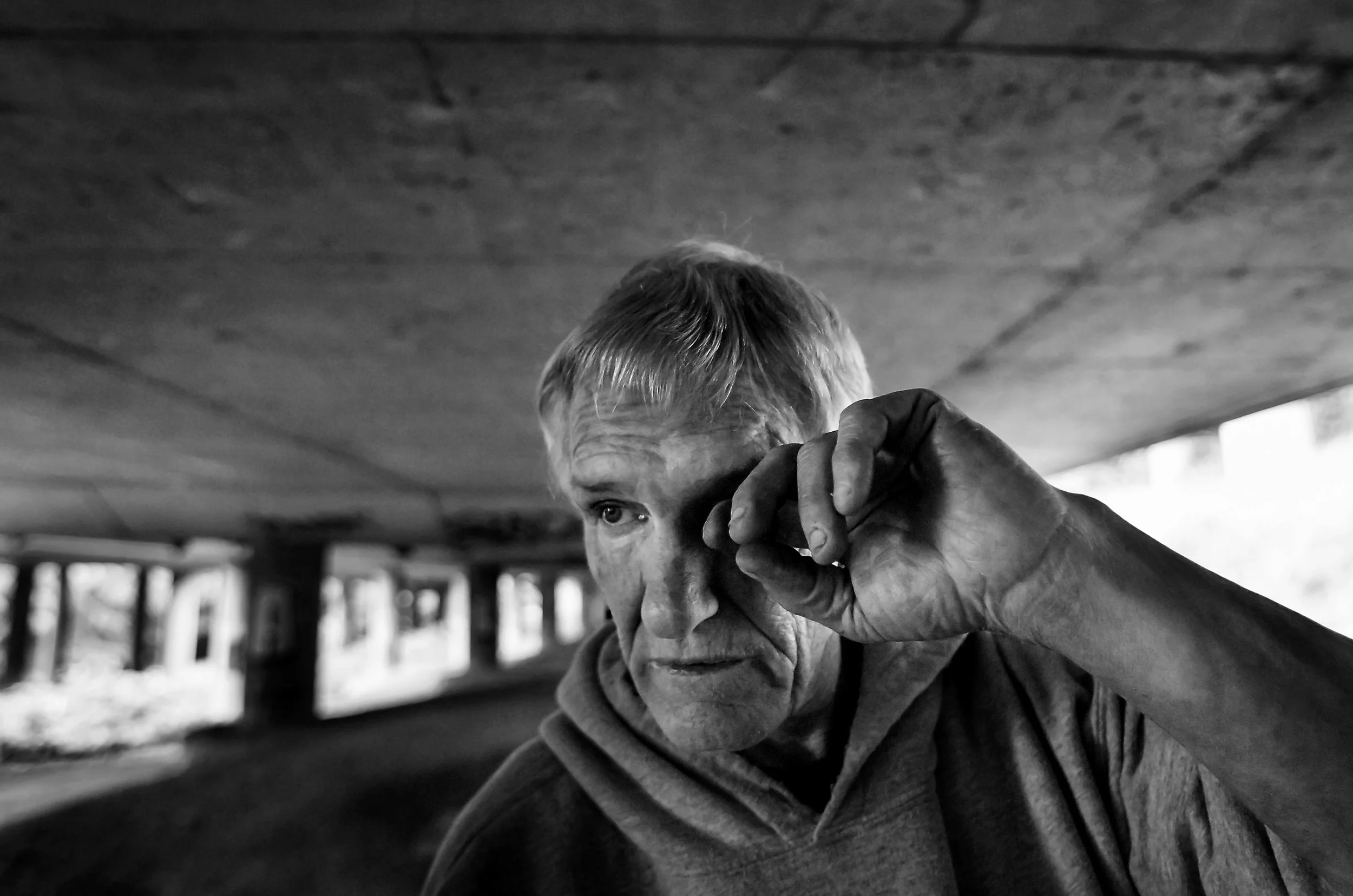 Donny, a 60-year-old resident who wanted to keep his last name anonymous, rubs his eye after cleaning his dishes at his home the Jungle, Thursday, May 26, 2016. A tally by outreach workers last month counted 336 people in 201 tents and structures that make up the Jungle.