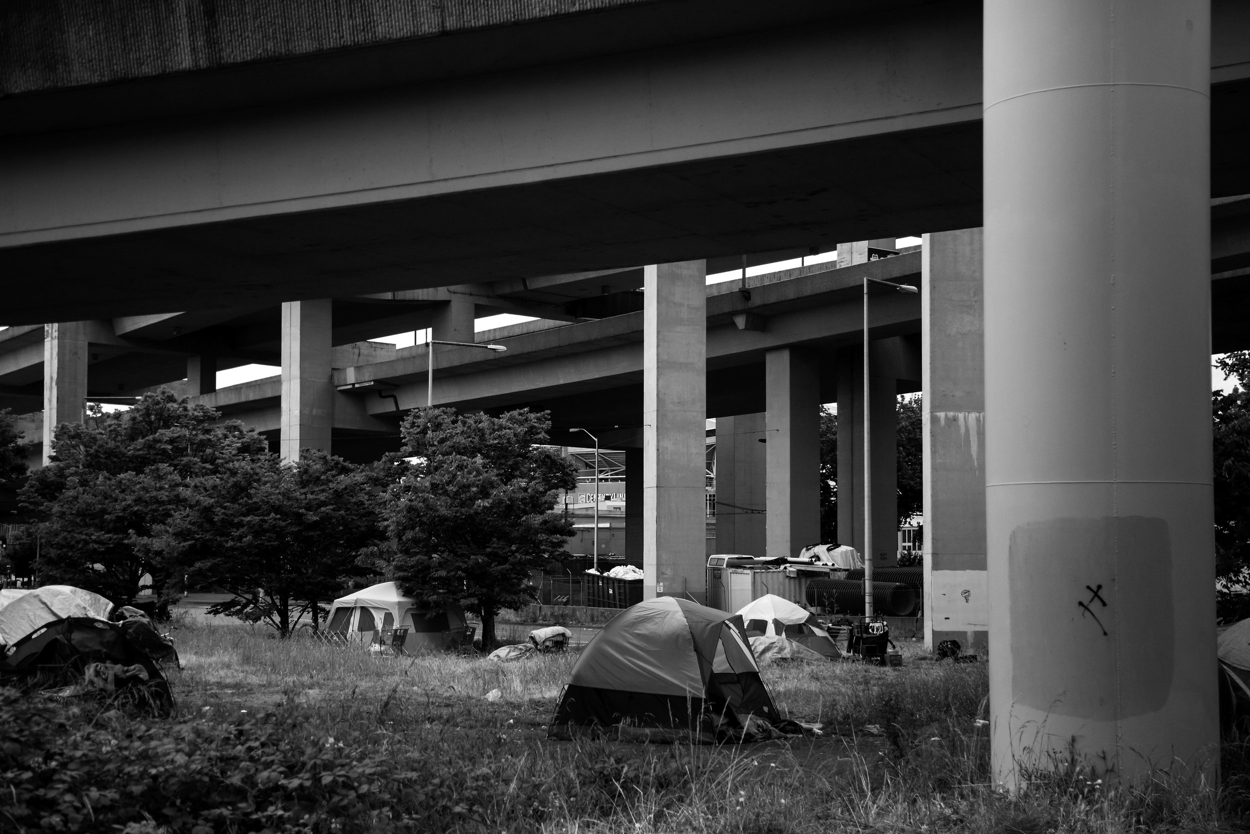  Over a dozen tents sit underneath Interstate 90 near the intersection of Airport Way South and South Royal Brougham Way, which is located near the Jungle, Friday, May 27, 2016. 