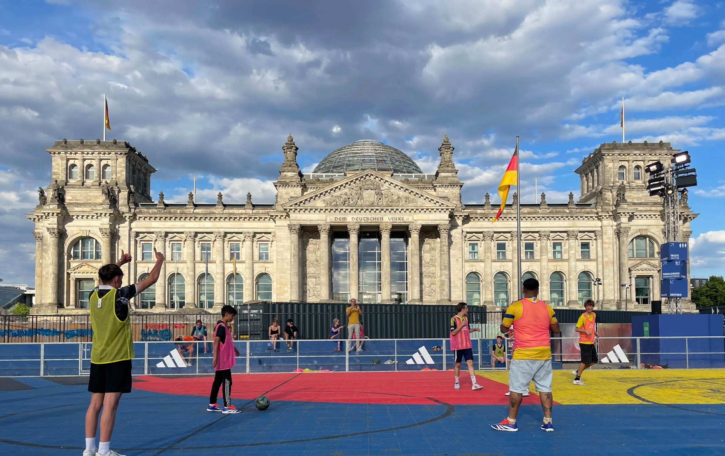 James (right) plays football in front of the Reichstag building