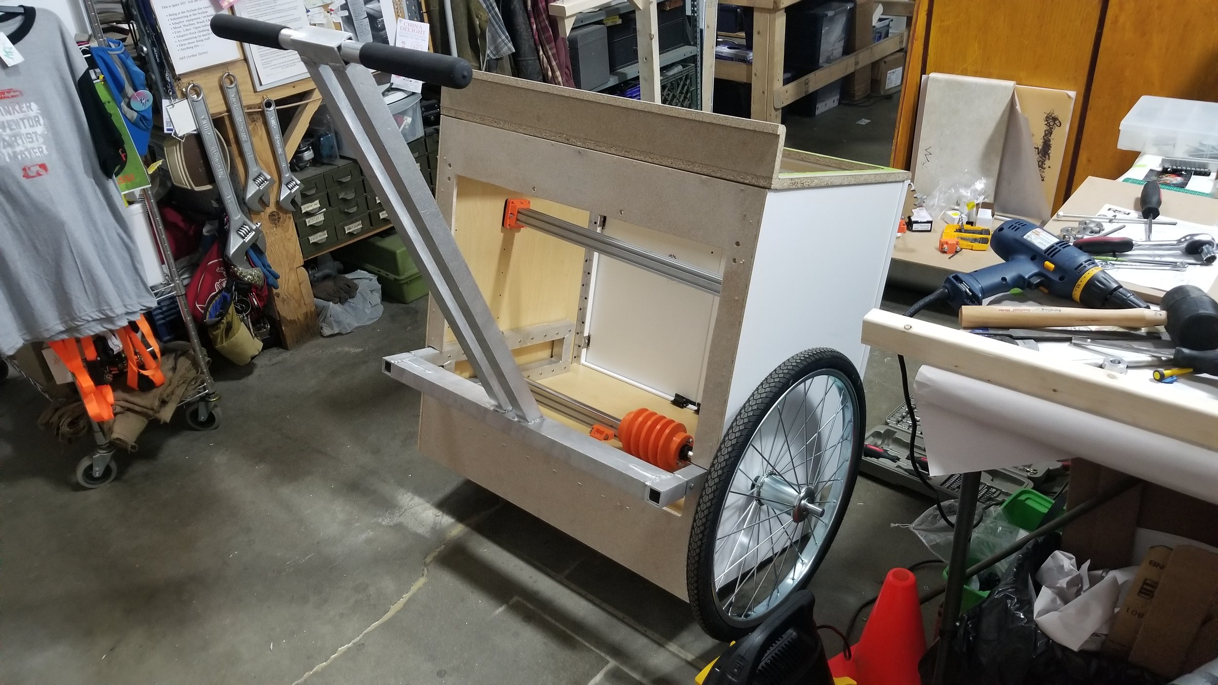 With the handlebar installed and the wheels on the side. The area where the main axle sits determined the rest of the placement.