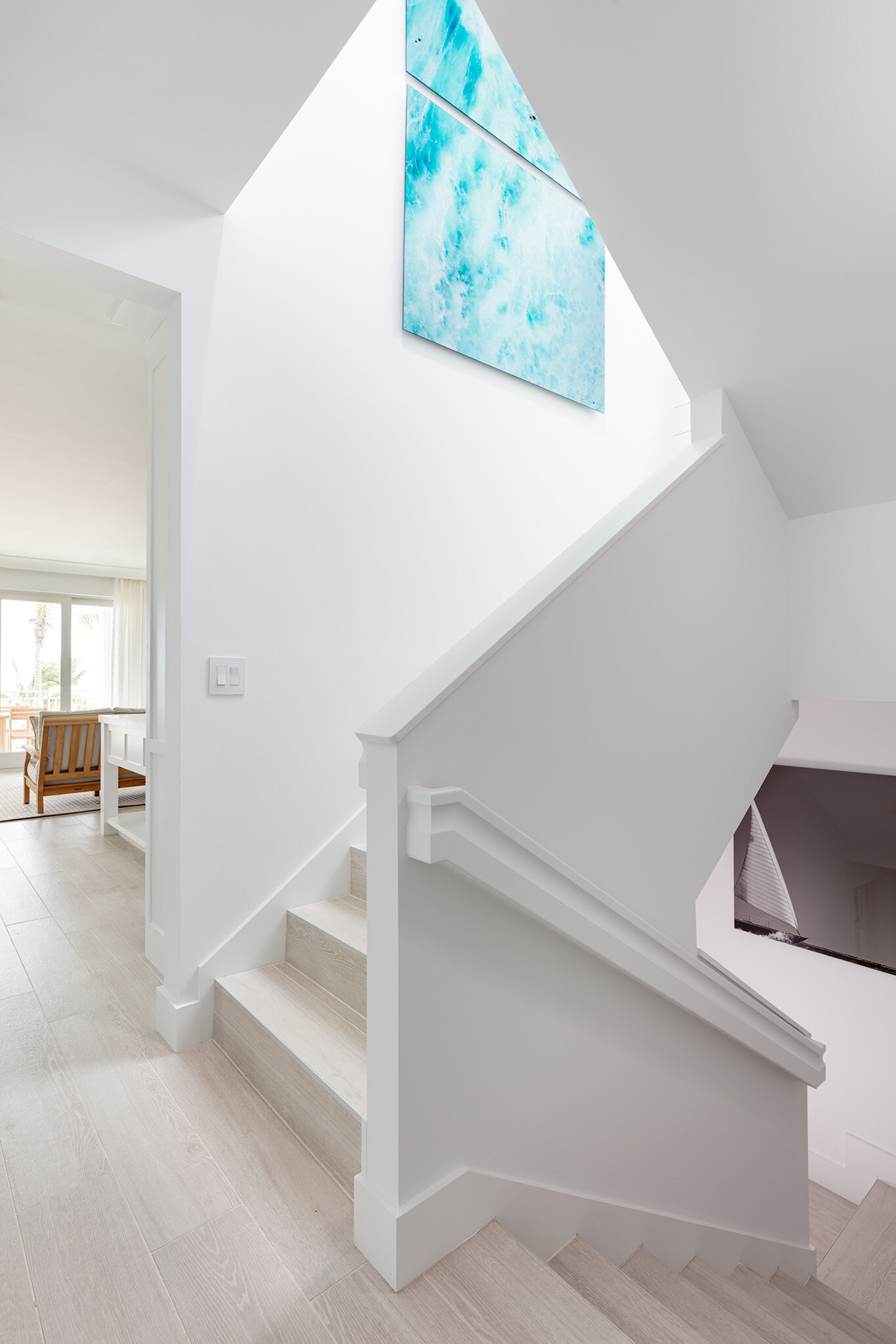  First-floor stairway leading up to the second floor and down to the ground level of an Islands waterfront villa. 