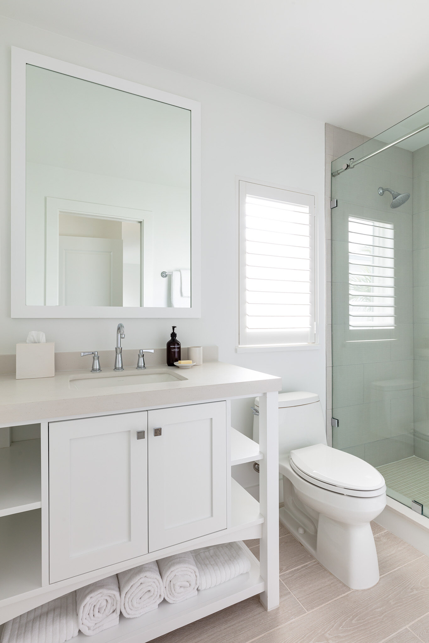  Furnished bathroom with shower stall, sink, and toilet in an Islands waterfront villa. 