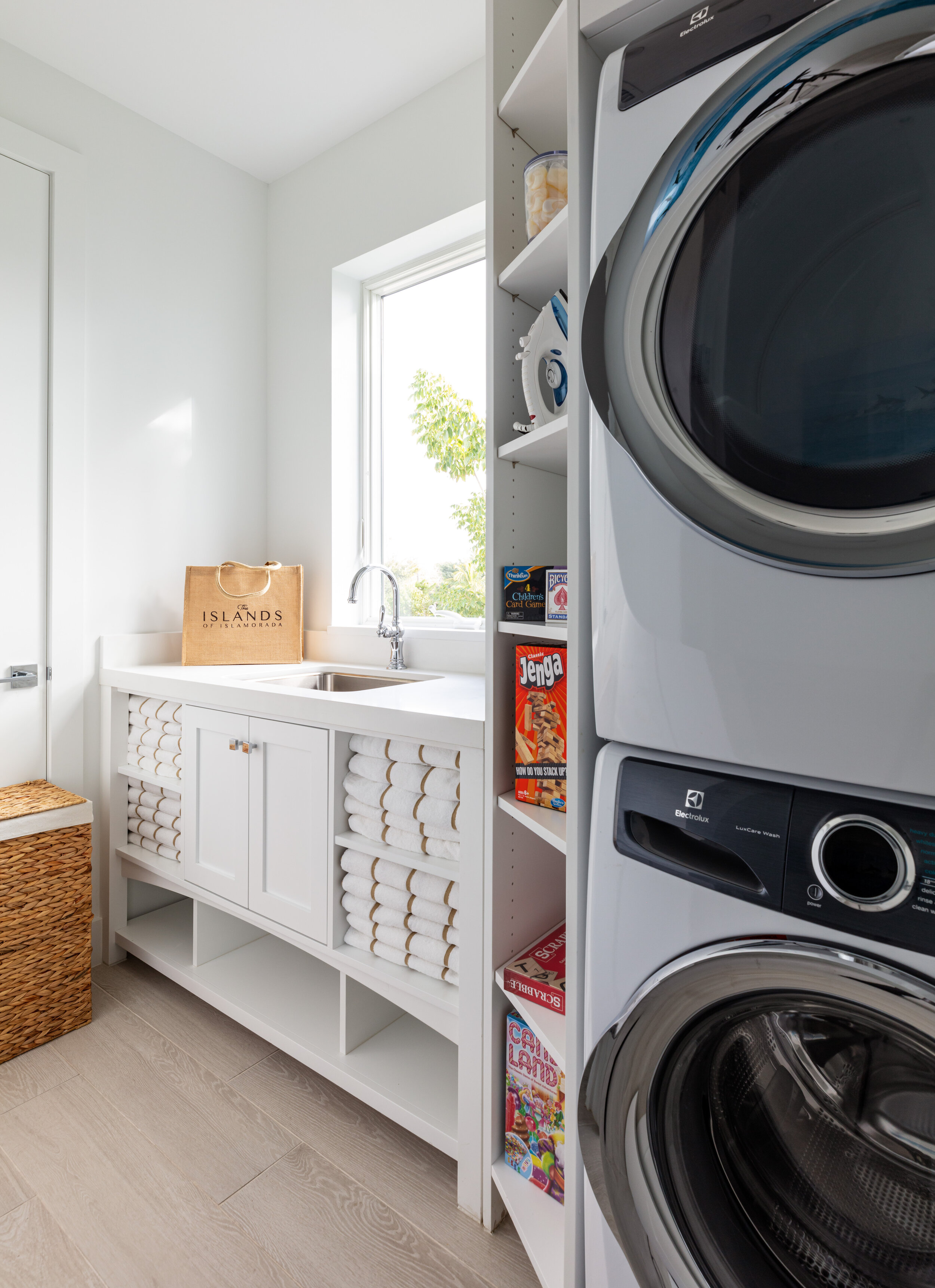  Laundry room in an Islands waterfront villa with washer, drier, and towel cabinet. 
