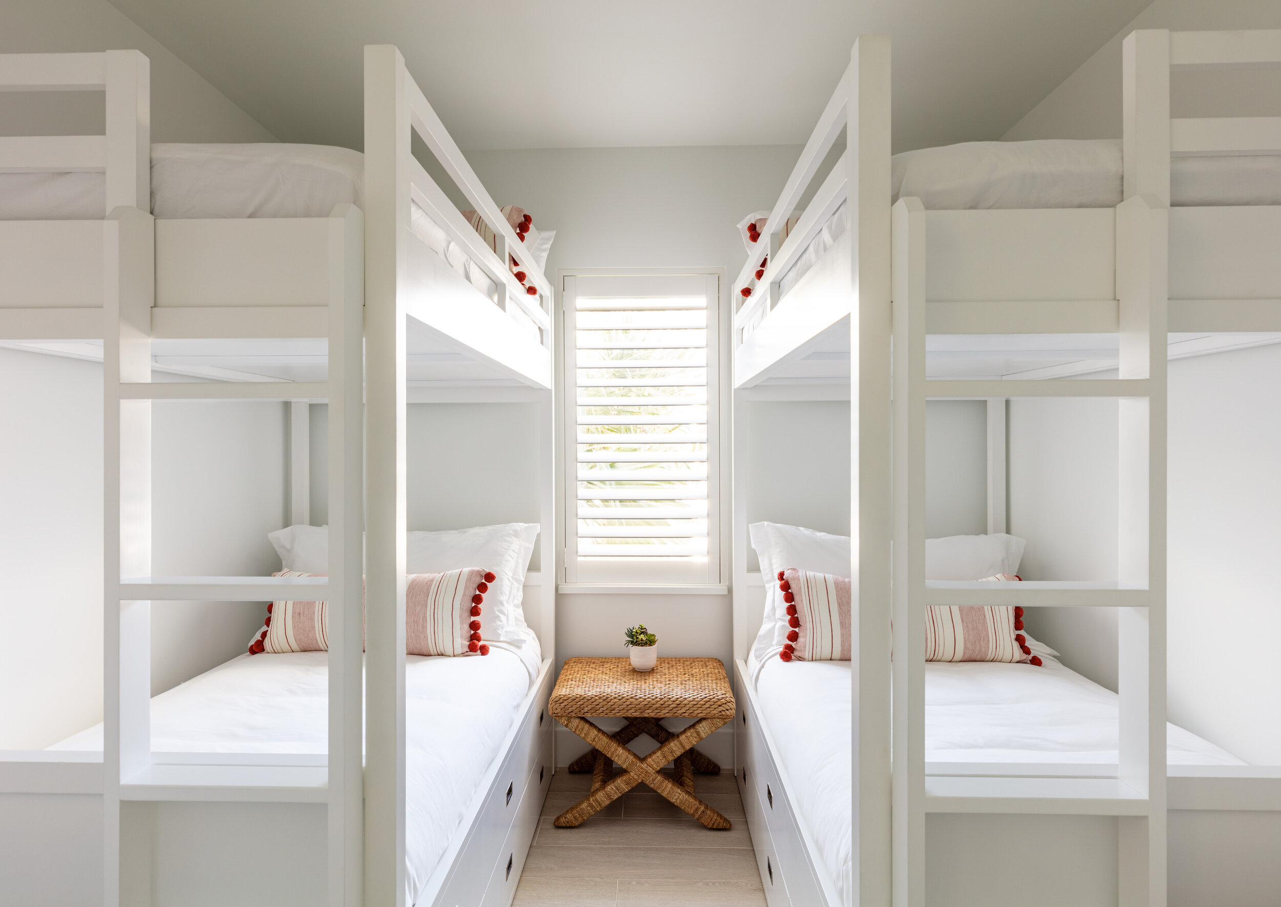  Two sets of bunkbeds in an Islands waterfront villa second-floor bedroom. 