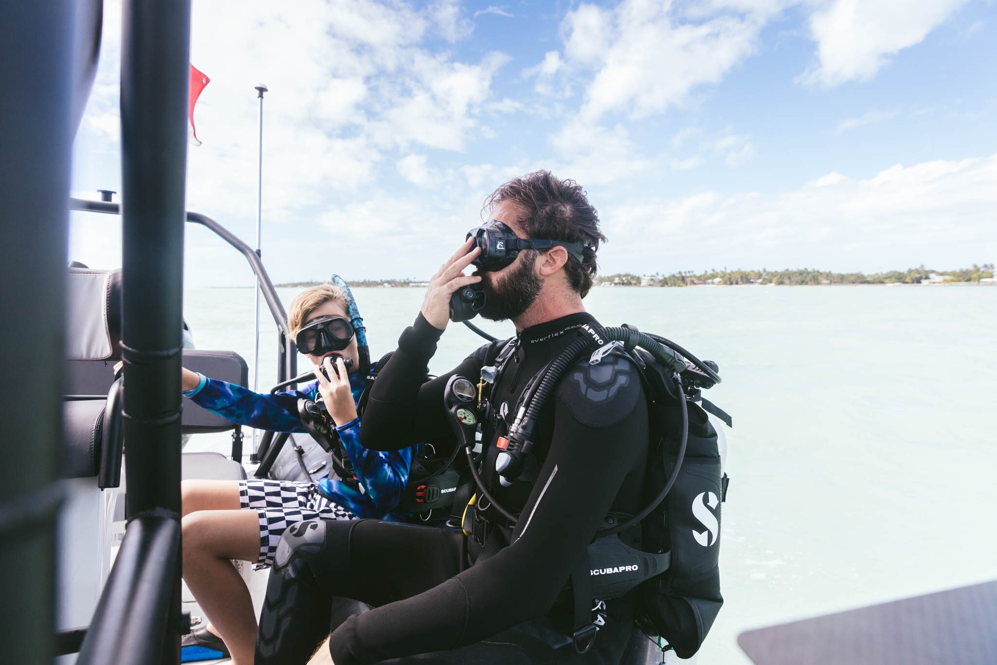  Father And Son In Scuba Gear Prepare To Dive From A Boat Into The Crystal Clear Atlantic Ocean Off The Islands Of Islamorada Florida’s Private Beach. 