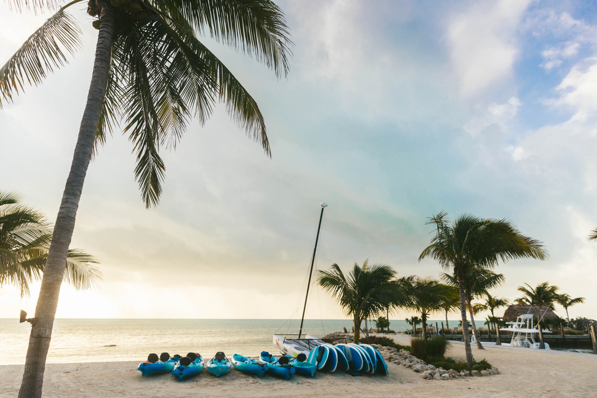  Row of kayaks and paddleboards on The Islands of Islamorada’s private beach as the sun rises over the Atlantic Ocean. 