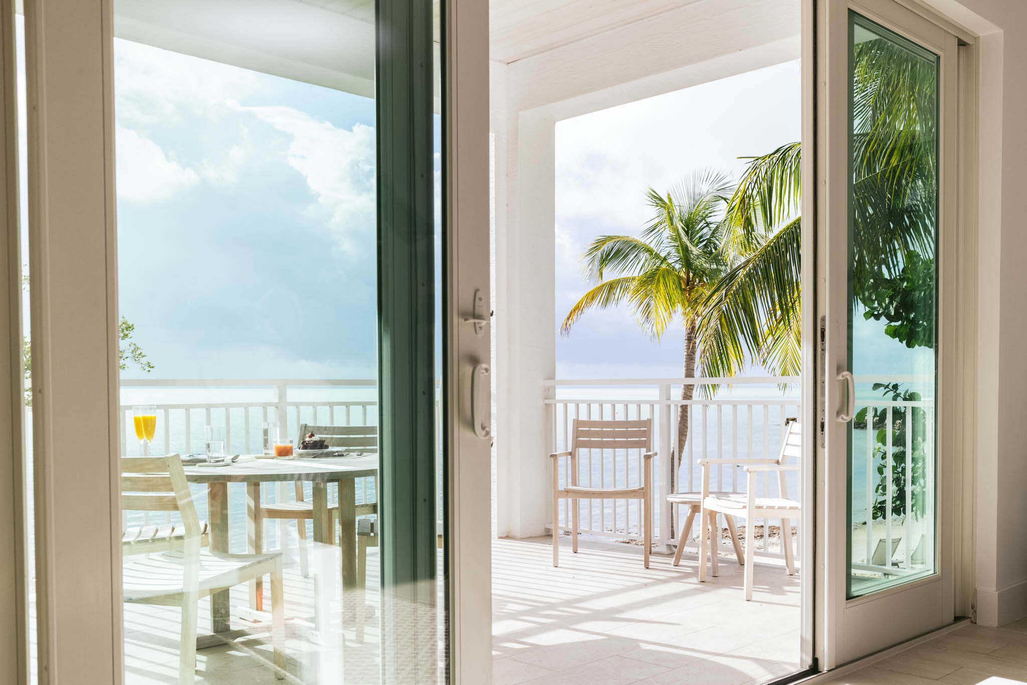  Sliding glass door to the ocean view covered balcony on the first floor of an Islands waterfront villa. 
