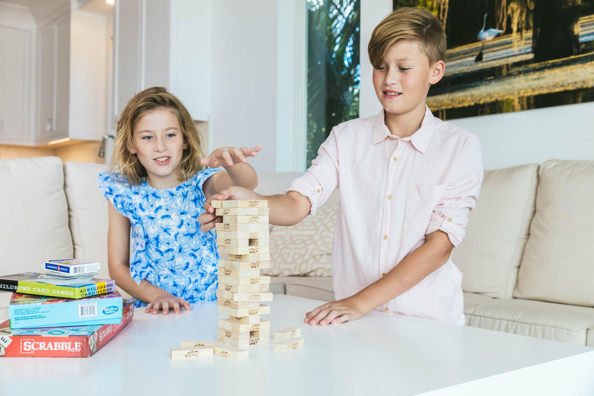  Two kids play a game of Jenga in the living room of Islands waterfront villa. 