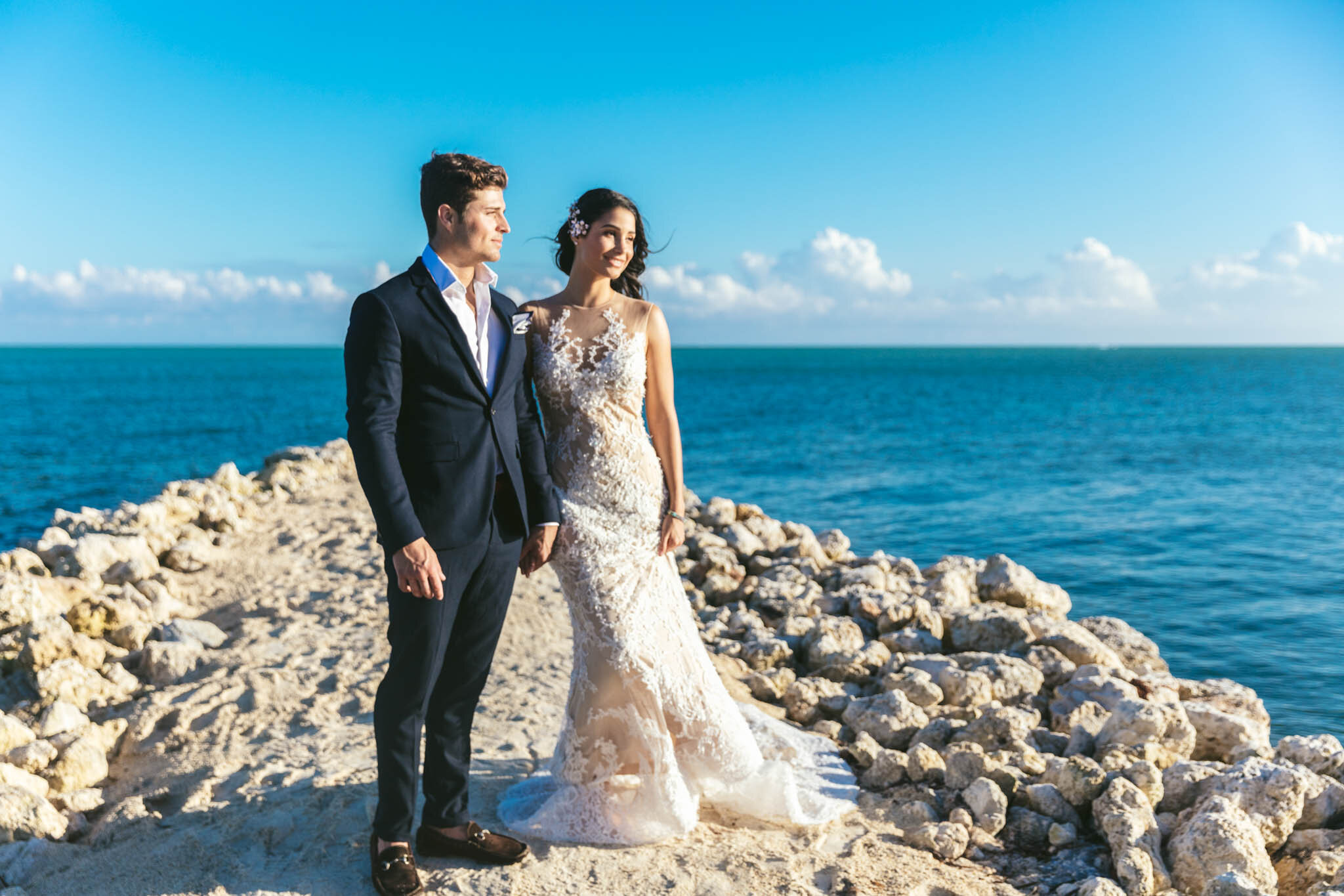  Bride and groom look out onto the Atlantic Ocean while standing together on The Islands of Islamorada’s private jetty. 