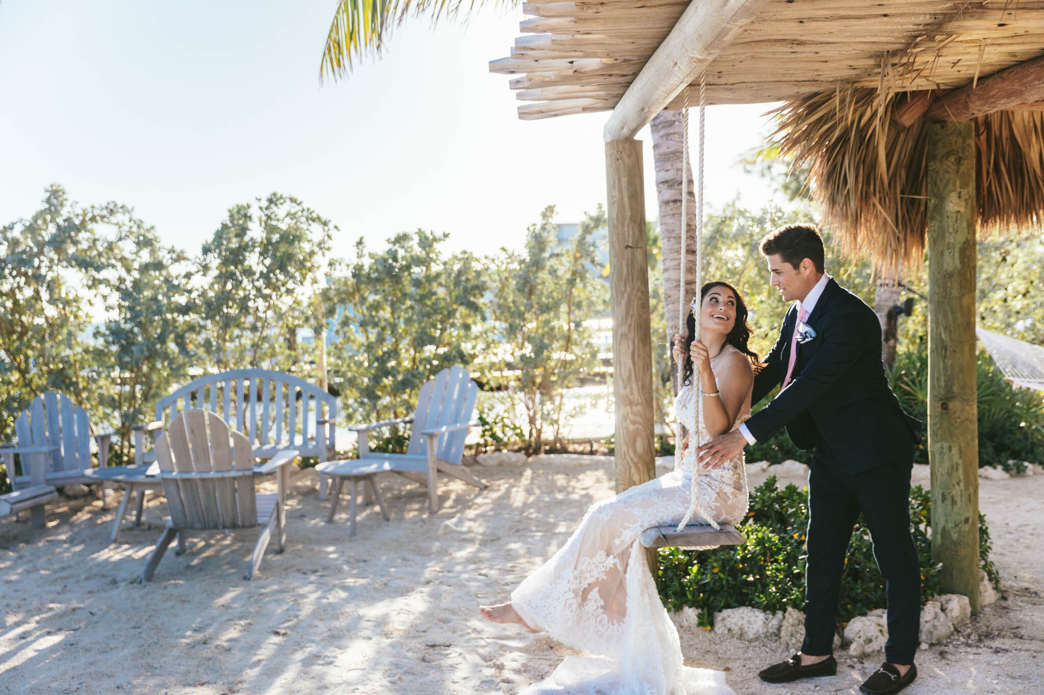  Groom pushes his bride on a swing under The Islands of Islamorada’s beachside tiki bar hut. 