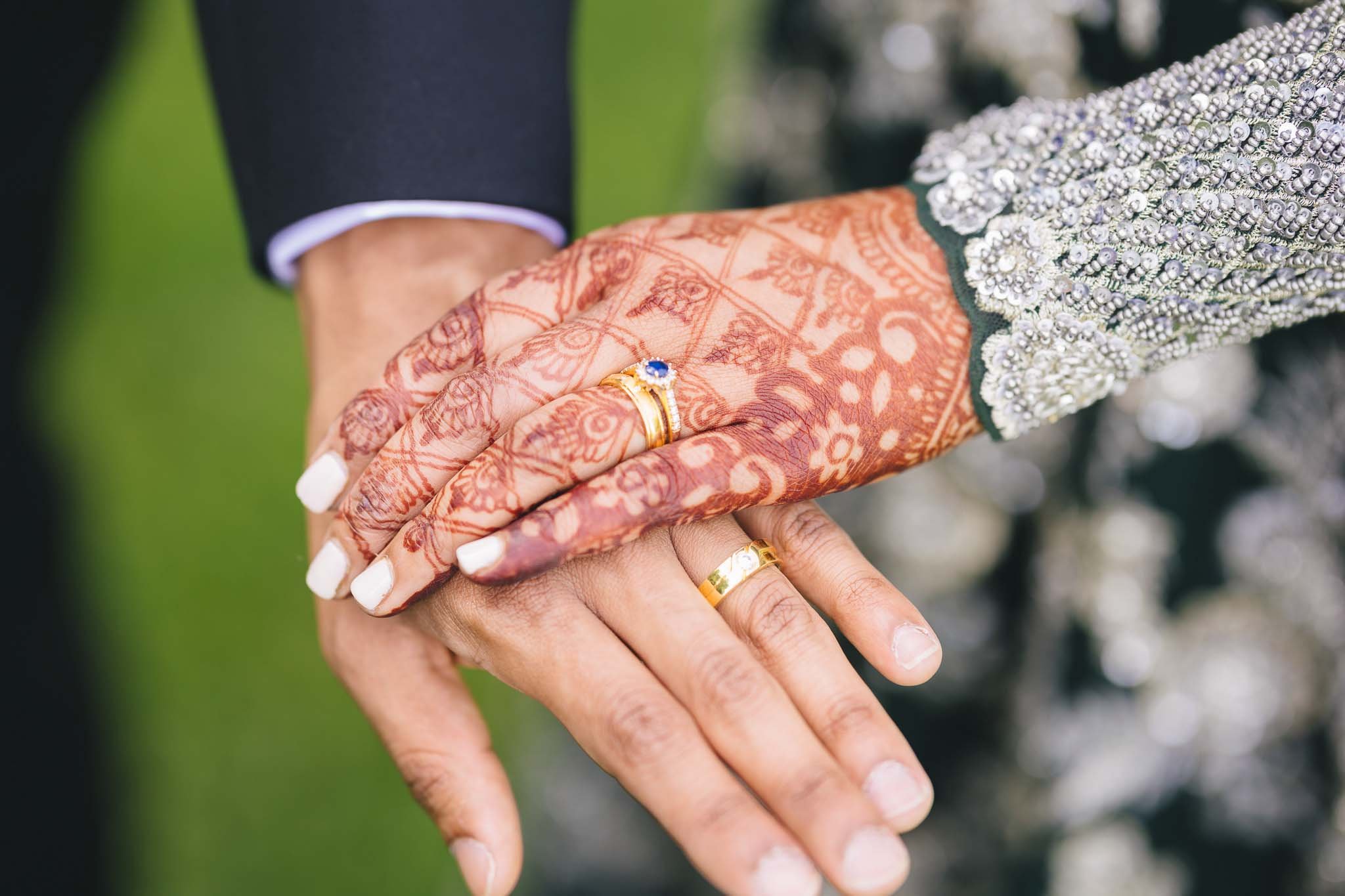 wedding couple holding hands with bride henna