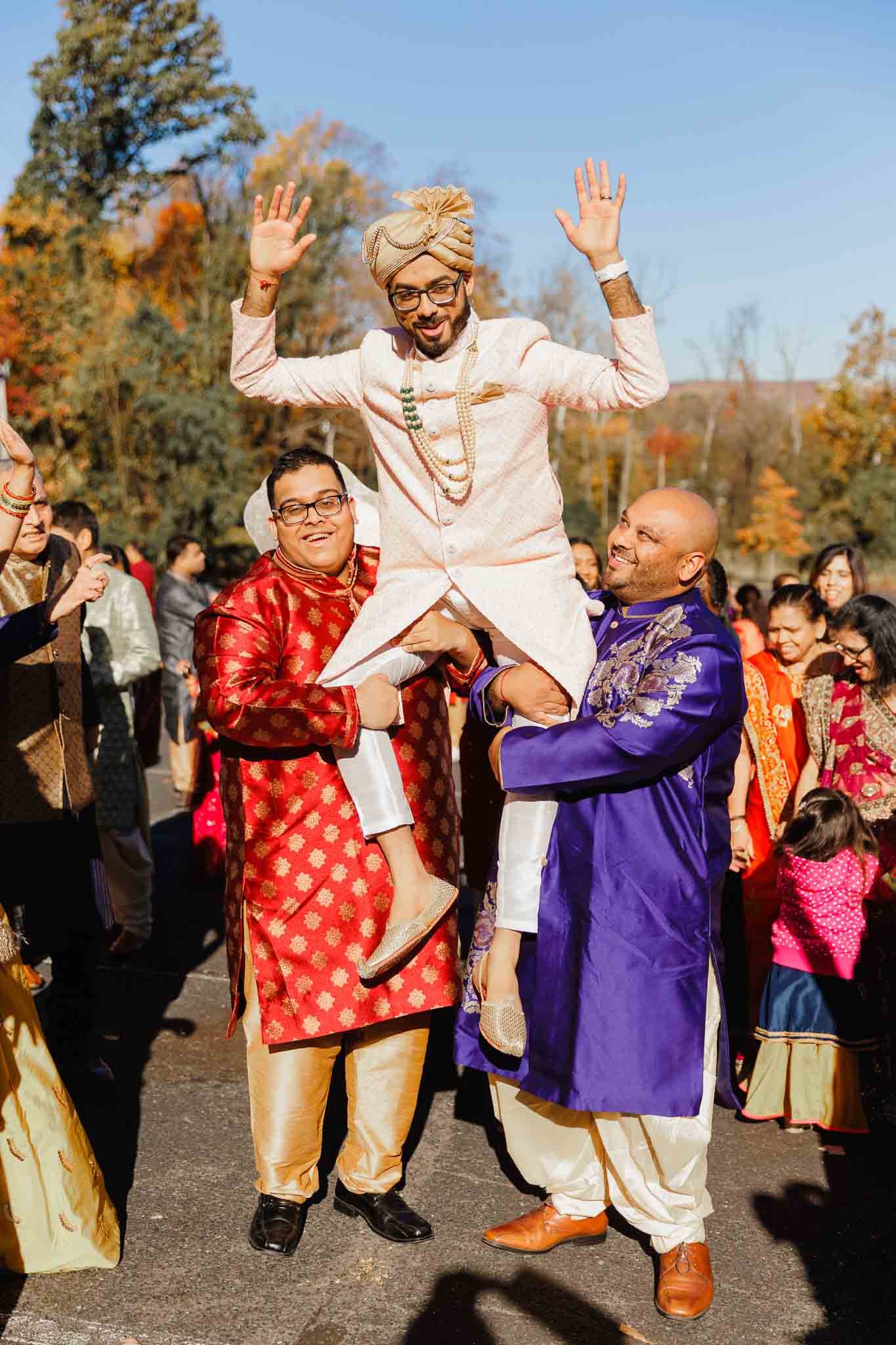Indian groom lifted in air by his friends