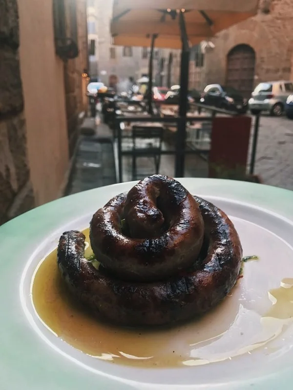 The silly joke was not about how the sausage looked like a poop coil...