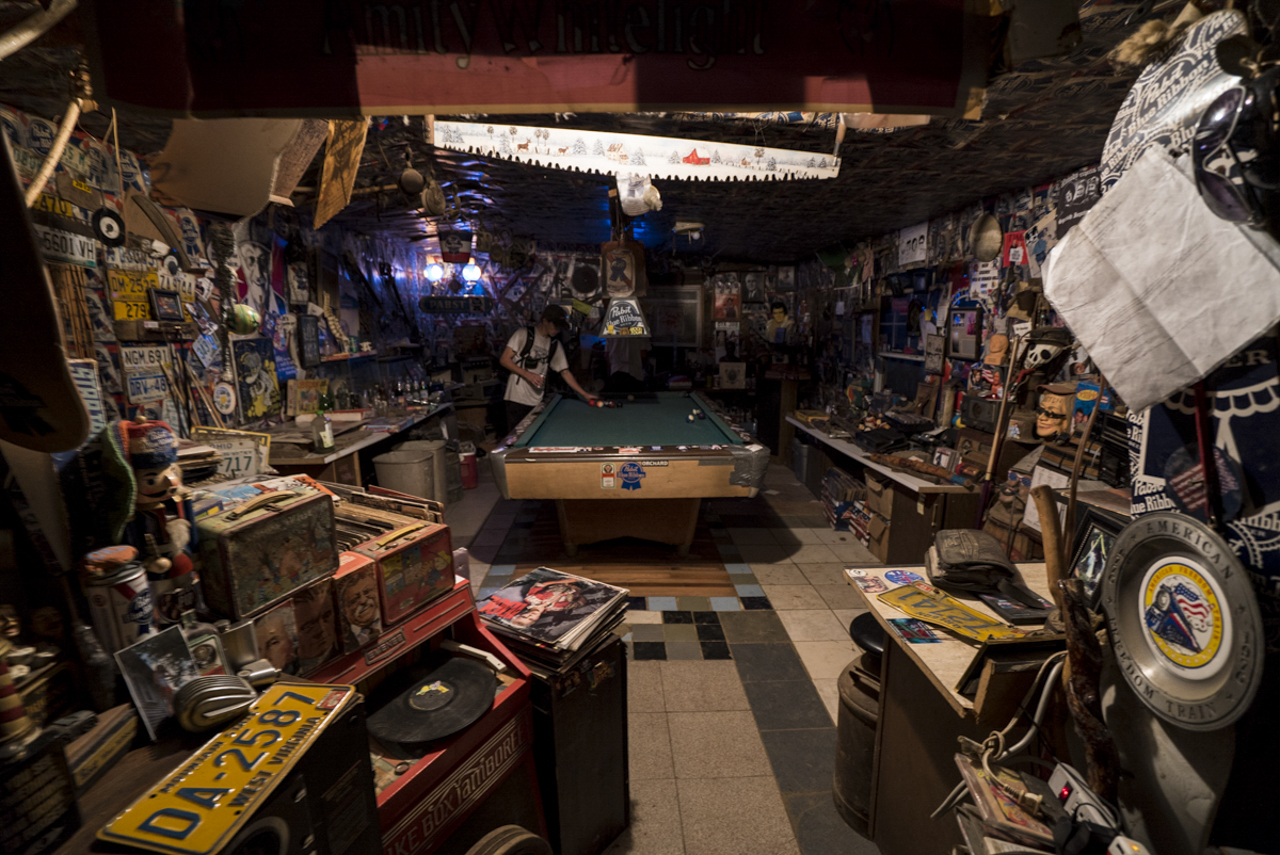 John Dwyre racks up balls on the pool table in the Pabst House at Skatopia.