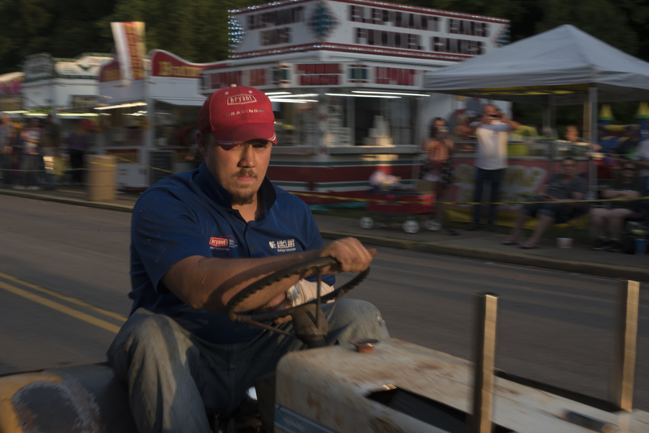 Don Beavers rides his tractor through the New Straitsville Moonshine Festival