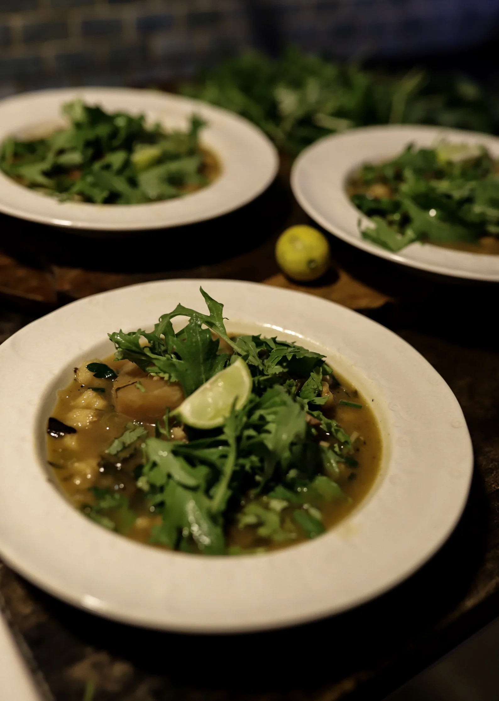 Pozole Soup, topped with fresh cilantro, mizuna , and lots of lime!