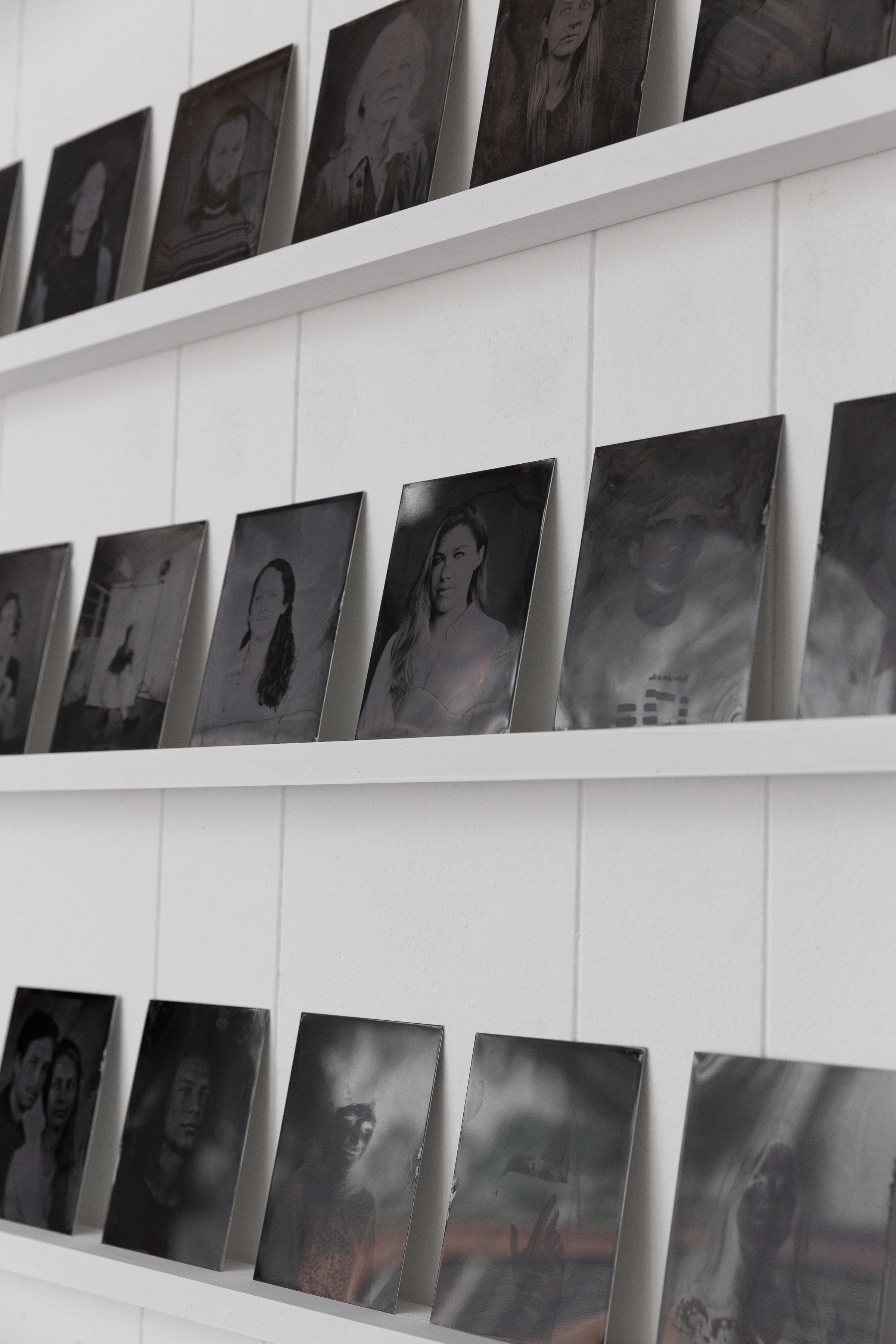 Plates are displayed on custom-built shelves in order for the viewer to get close and view the chemical quality of each piece.