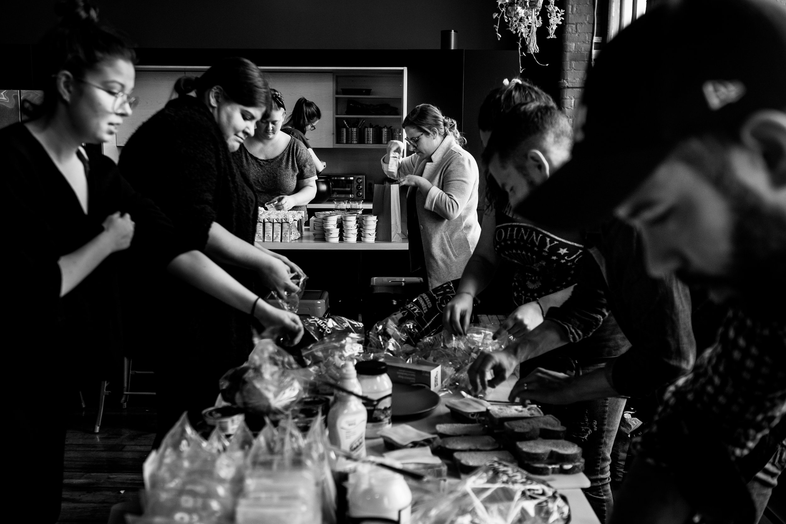 The sandwich makers: Molly, Kayla, Mandy, Daniel, Adrian, at work while our Team Happiness Manager Cassie stuffs paper bags in the background.