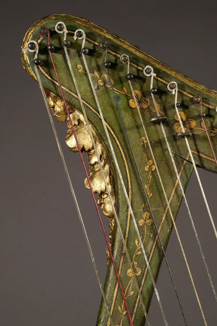 Historic Irish harp with polychrome details - close-up gilded carving