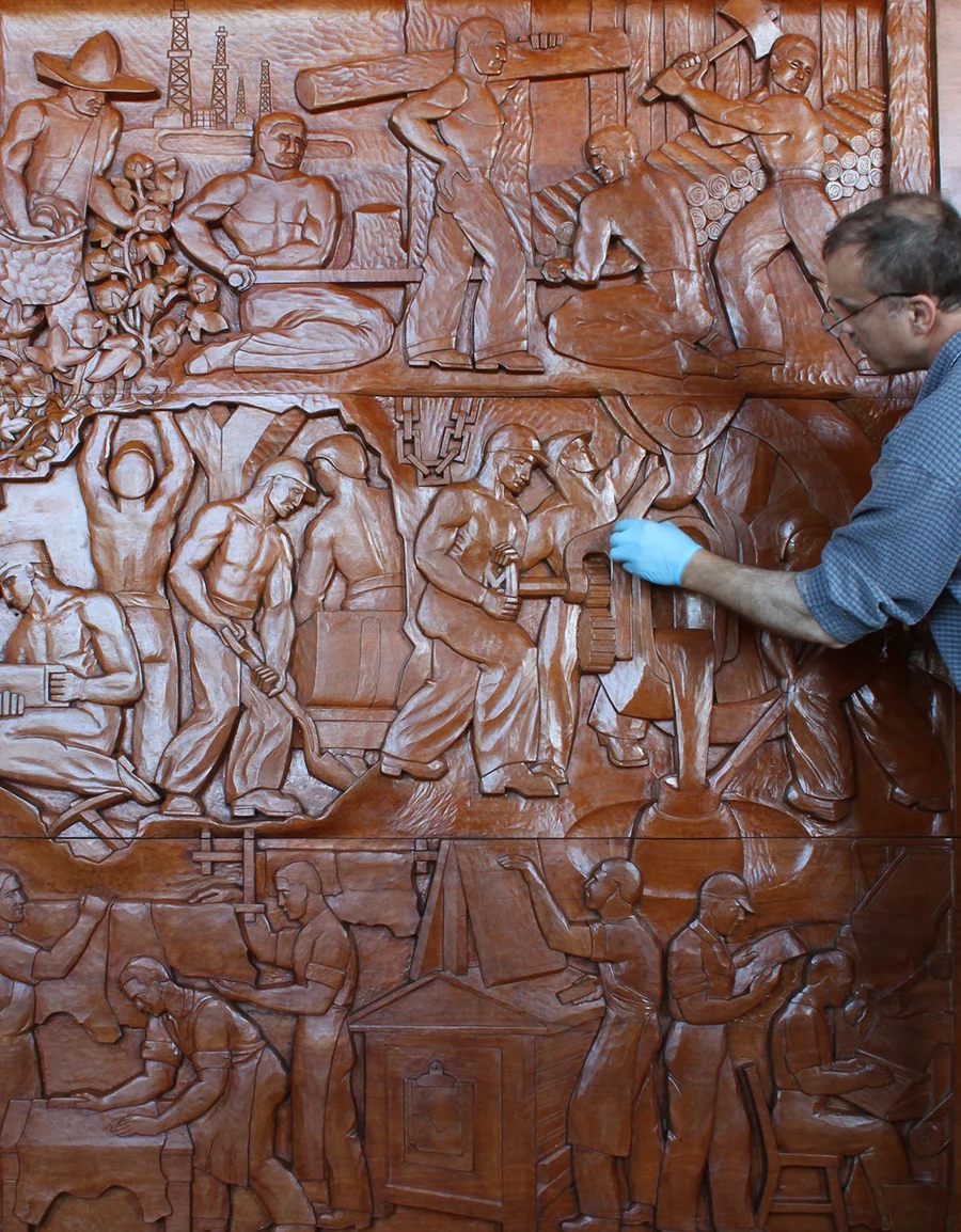Photo: The Evolution of the Book, Wood Sculptural Relief by Peterpaul Ott, during conservation, final finish touch ups
