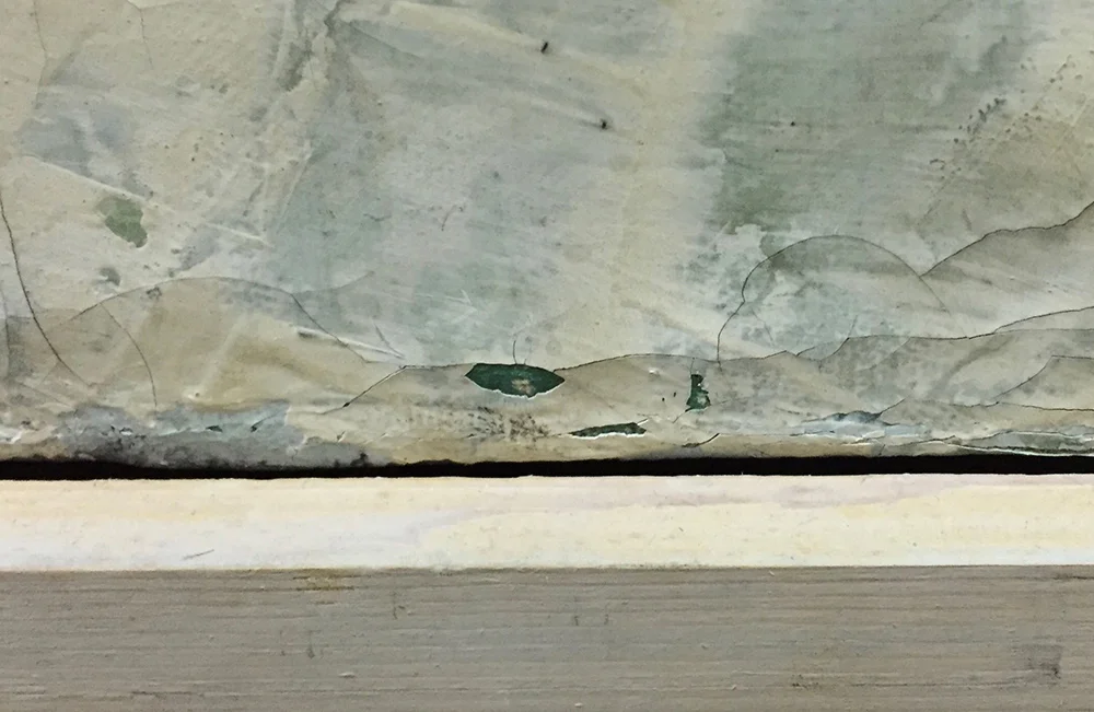 Areas of paint loss resultant from cleaning of an unstable paint layer