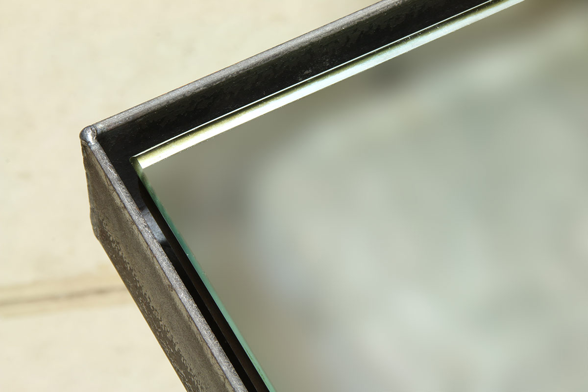 Steel float frame hosting a mirror