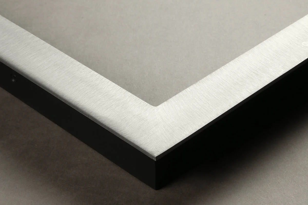 Detail of an 1.25” wide molding steel frame with brushed satin finish